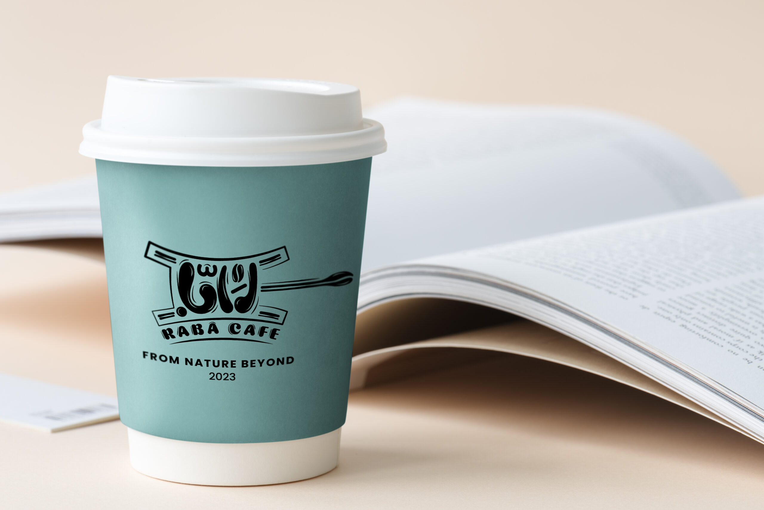 Takeaway coffee cup mockup on a table with an open book